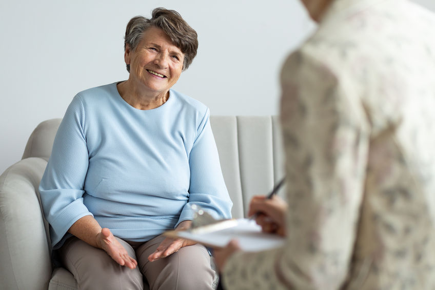 Elderly woman talking to a financial advisor about a loan during appointment